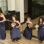 Junior bridesmaids and bridesmaid walking up steps.