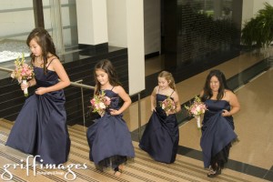 Junior bridesmaids and bridesmaid walking up steps.