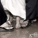Bride and bridesmaids showing off their blinged out shoes.