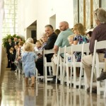 Adorable ring bearer making his way down the aisle during the wedding ceremony.