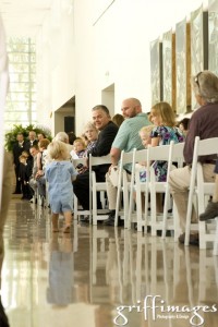 Adorable ring bearer making his way down the aisle during the wedding ceremony.