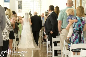 Bride and father from the back walking down the aisle.