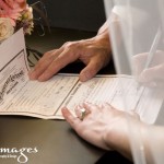 Close up of the bride signing the marriage certificate, photo by Amanda Griffin / Griffimages/