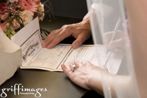 Close up of the bride signing the marriage certificate, photo by Amanda Griffin / Griffimages/