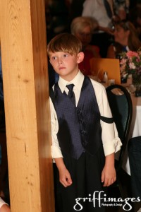 One of the junior groomsmen watching the happy couple during their first dance.